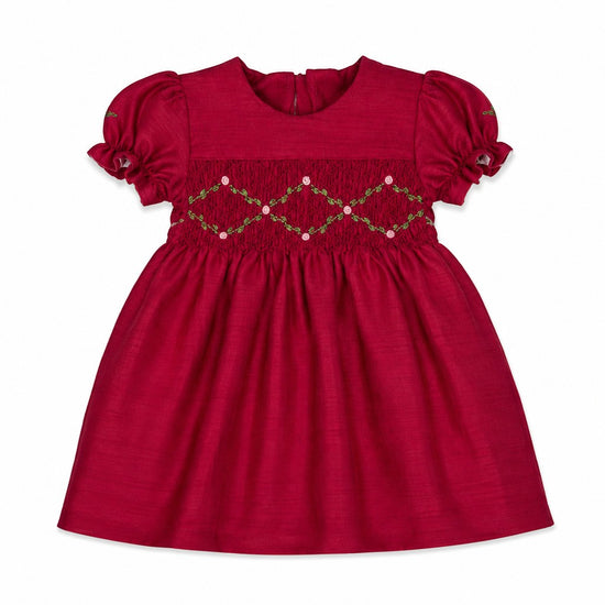 Carriage Boutique red baby girl dress with smocked floral embroidery, puffy sleeves, and a round neck in poly silk.