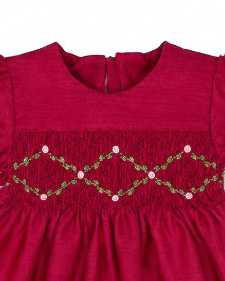 Carriage Boutique red silk baby dress with smocked floral embroidery, round neck, and puffy short sleeves.