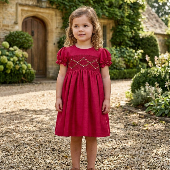 Carriage Boutique toddler girl red silk dress with smocked floral chest detail and puffy short sleeves