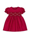 Carriage Boutique red silk baby girl dress with smocked floral embroidery, puffy sleeves, and a round neck.