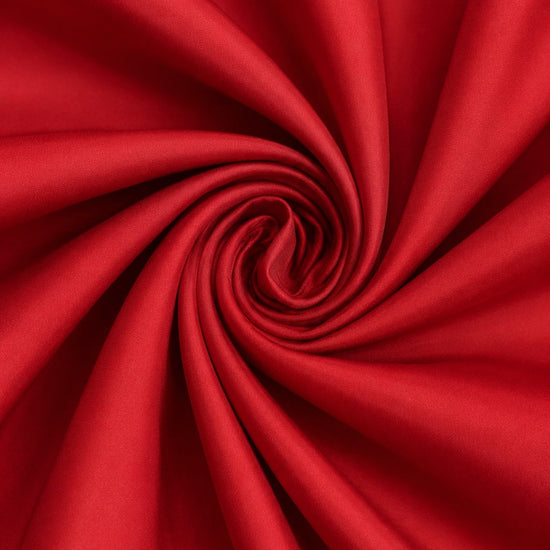 Carriage Boutique red taffeta fabric swirl showing smooth texture and vibrant color for a baby dress