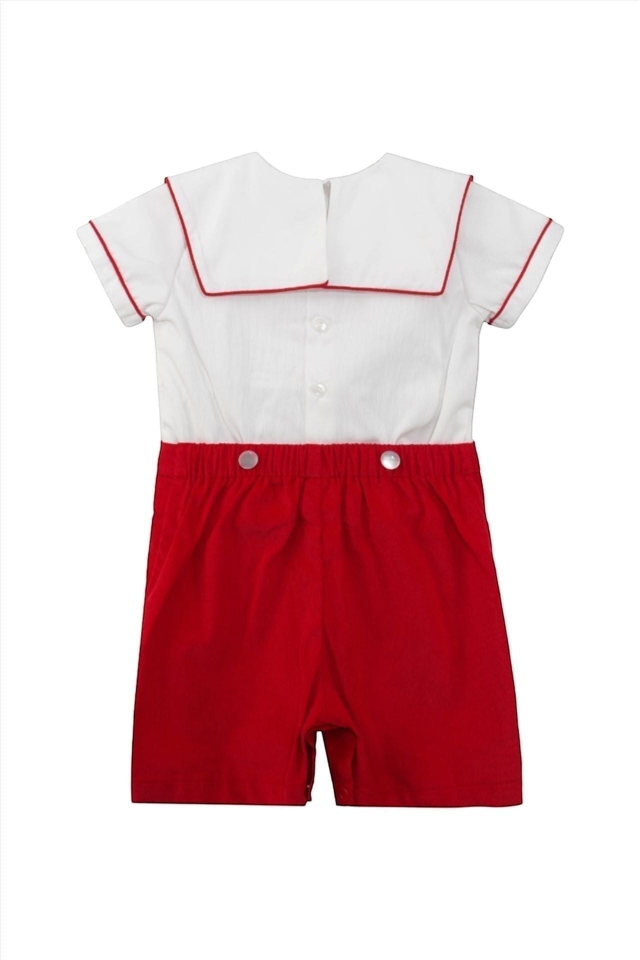 Carriage Boutique red and white cotton infant boy bobbie suit with smocked bib and wooden soldier motif.