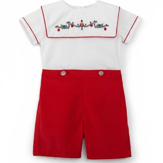 Carriage Boutique red corduroy shorts and white smocked bib shirt with wooden soldier and bird embroidery. 100% cotton.