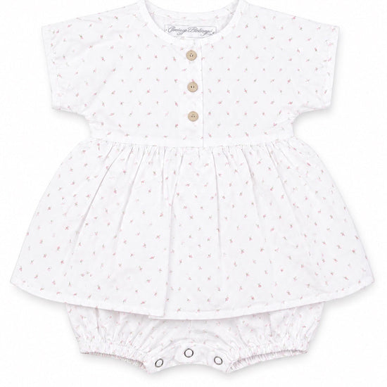 Carriage Boutique white baby girl dress with pink rosebud print, wooden buttons, and attached bubble bloomers.