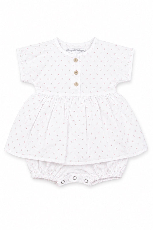 Carriage Boutique white baby girl dress with pink rosebud print, wooden buttons, and attached bubble bloomers.