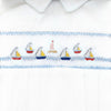 Carriage Boutique white bubble romper with smocked sailboat and lighthouse embroidery, Peter Pan collar, and blue piping.