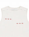Carriage Boutique white sleeveless baby bubble with smocked detailing and embroidered red sailboats. Button closure.
