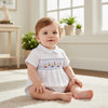 Carriage Boutique white bubble romper with smocked sailboat and lighthouse embroidery, Peter Pan collar, and blue piping.
