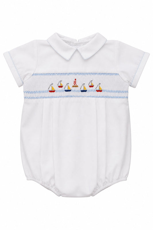 Carriage Boutique white bubble romper with smocked chest featuring sailboats and lighthouse, Peter Pan collar, blue piping.