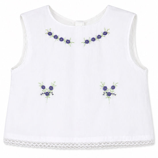 Carriage Boutique sleeveless white cotton baby top with lilac flower bullion embroidery and lace hem detail
