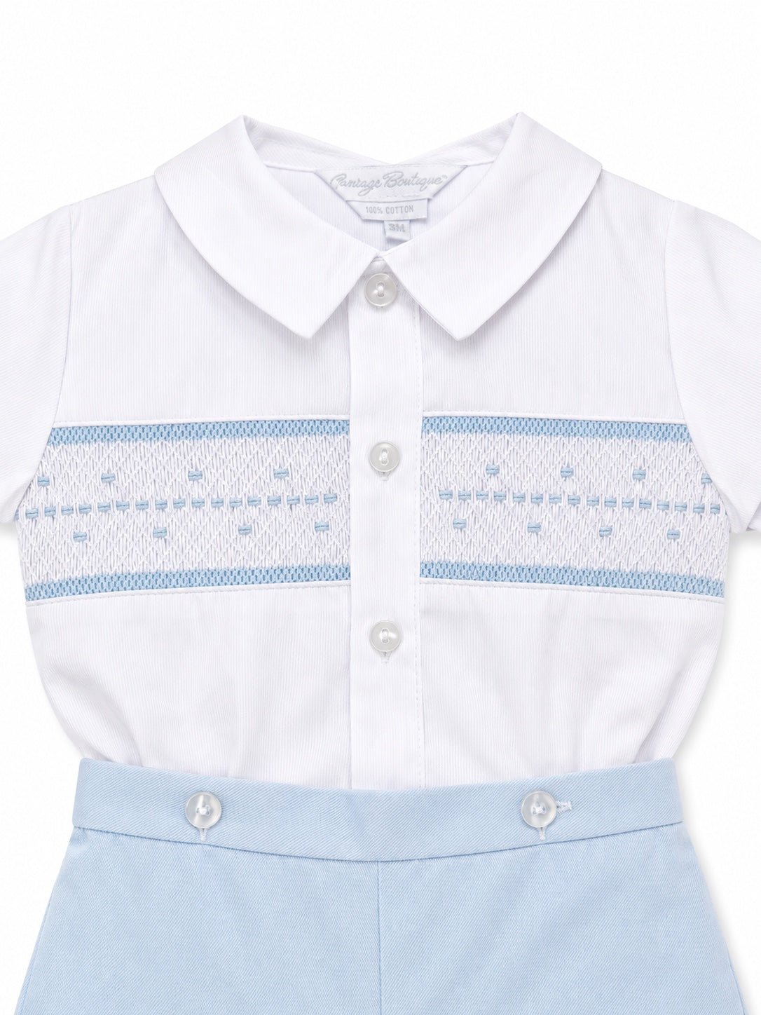 Carriage Boutique infant boy bobby suit with white collared shirt, hand smocking, and light blue cotton shorts.