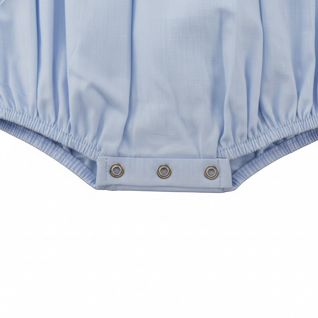 Carriage Boutique light blue smocked bubble romper with Peter Pan collar and train motif. Short sleeves, button back.