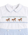 Carriage Boutique white baby bobby suit with blue trim and carousel horse smocking detail on the chest