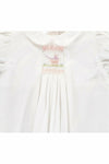 Carriage Boutique white baby dress with hand-smocked bodice, pastel pram embroidery, and Peter Pan collar.