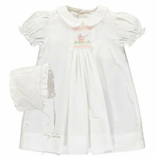 Carriage Boutique white smocked heirloom dress with pram embroidery, Peter Pan collar, and matching ruffled bonnet.