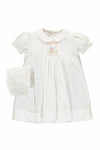 Carriage Boutique white smocked heirloom dress with pram embroidery, Peter Pan collar, and matching ruffled bonnet.