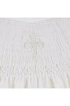 Carriage Boutique white cotton baby dress featuring intricate hand smocking and a delicate pearl cross detail.
