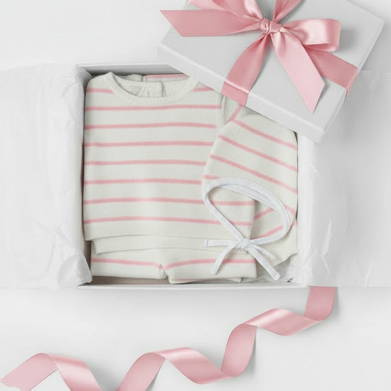 Carriage Boutique 3-piece baby gift set with cream and blush pink striped knit top, leggings, and matching bonnet.