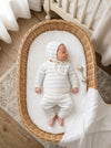 Carriage Boutique baby sleeping in a wicker basket wearing a white and sky-blue striped knit legging set with a hat.
