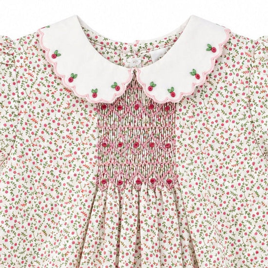 Carriage Boutique baby girl romper with tan floral print, white scalloped collar, and pink smocked diamond detail.