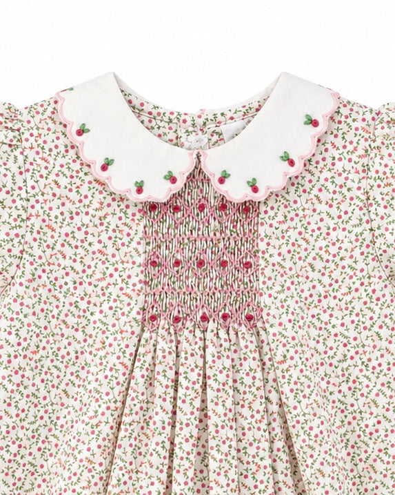 Carriage Boutique baby girl romper with tan floral print, white scalloped collar, and pink smocked diamond detail.