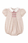 Carriage Boutique baby girl bubble romper in tan floral cotton with pink smocked diamond detail and puff sleeves