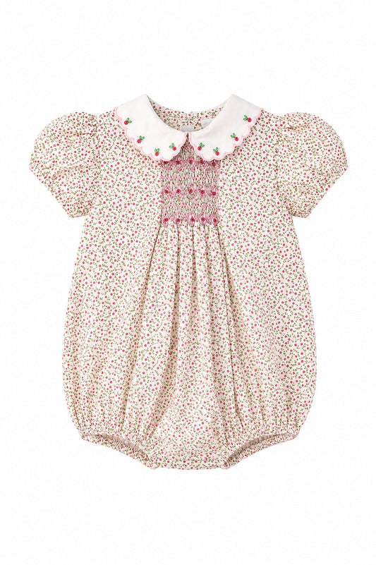 Carriage Boutique baby girl bubble romper in tan floral cotton with pink smocked diamond detail and puff sleeves