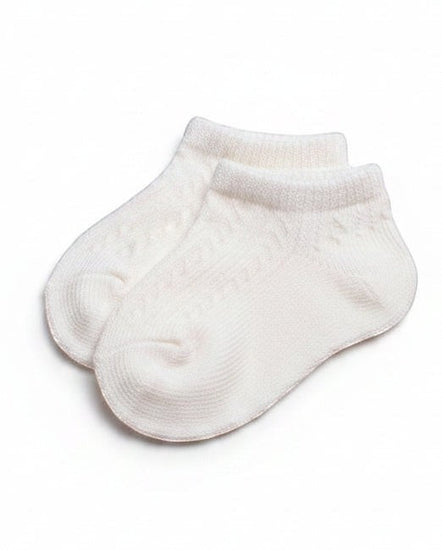 Carriage Boutique baby girls white ankle socks with a delicate diamond pattern and soft ribbed cuffs.