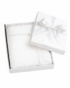 Carriage Boutique white baby blanket with lace trim and cross detail, presented in a gift box with a satin ribbon.
