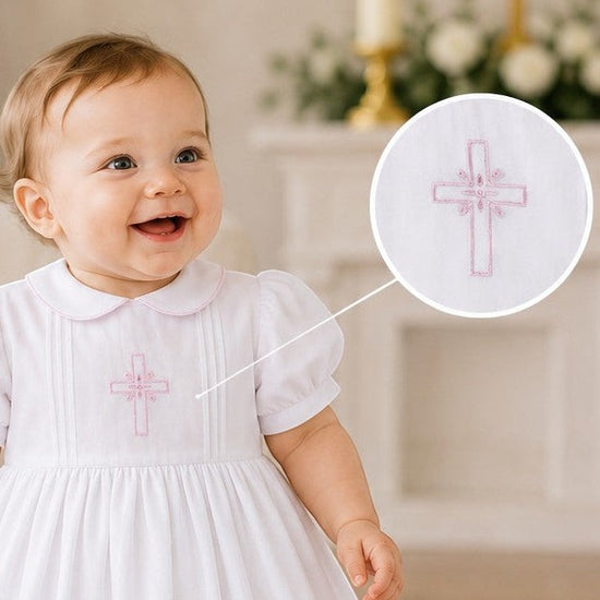 Carriage Boutique baby girl christening gown in white with pink embroidered cross detail and matching bonnet