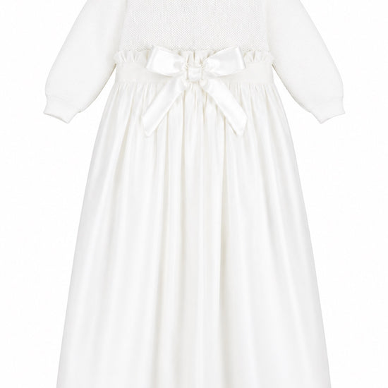 Carriage Boutique white baby girl christening gown with pebble stitch bodice, Peter Pan collar, and satin waist bow.