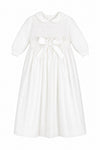 Carriage Boutique white baby girl christening gown with pebble stitch bodice, Peter Pan collar, and satin waist bow.