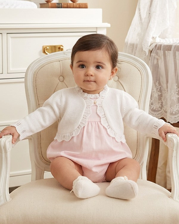 Carriage Boutique white cotton bolero shrug with textured knit pattern and single button on a baby girl