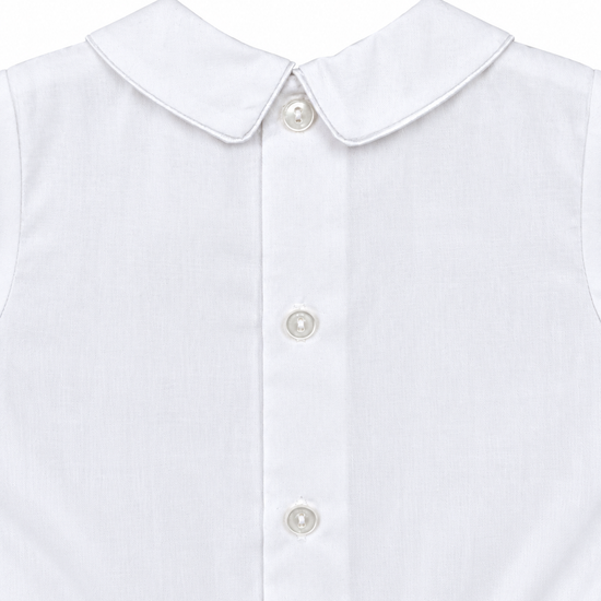 Carriage Boutique white cotton boys bobby suit featuring a Peter Pan collar and elegant satin button detailing.
