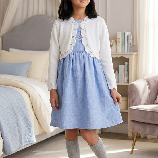 Carriage Boutique white cotton knit bolero shrug with textured pattern and single button closure on a young girl
