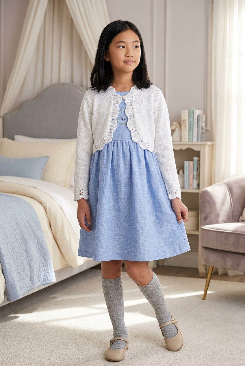 Carriage Boutique white cotton knit bolero shrug with textured pattern and single button closure on a young girl