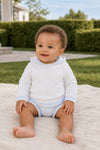 Carriage Boutique baby boy wearing a white hooded cotton sweater with light blue striped trim, sitting on a blanket.