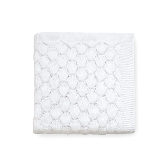 Carriage Boutique white 100% cotton baby knit blanket with a textured shell pattern, folded for a nursery.