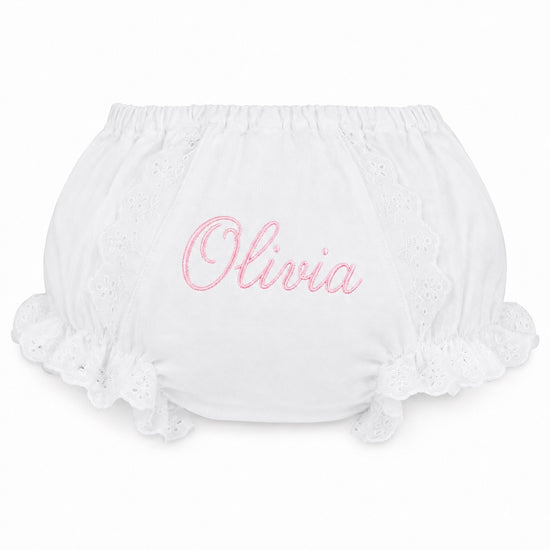 Carriage Boutique white cotton baby diaper cover with pink embroidered name Olivia and delicate lace ruffle trim.