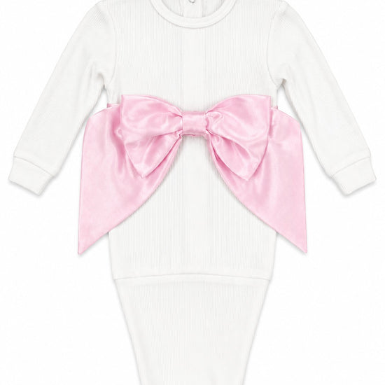 Carriage Boutique newborn white cotton swaddle bag featuring a large satin pink bow on the front