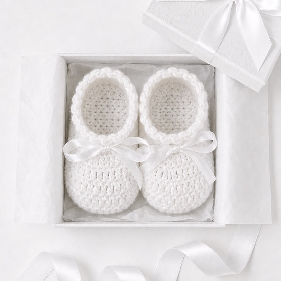 Carriage Boutique white crochet baby shoes with satin bows in a gift box, perfect for a Christening outfit.