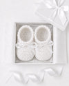 Carriage Boutique white crochet baby shoes with satin bows in a gift box, perfect for a Christening outfit.
