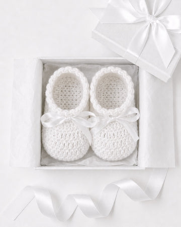 Carriage Boutique white crochet baby shoes with satin bows in a gift box, perfect for a Christening outfit.