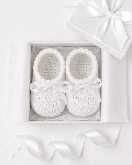Carriage Boutique white crochet baby shoes with satin bows in a gift box, perfect for a Christening outfit.