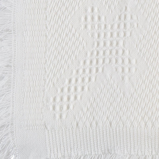 Carriage Boutique white baby blanket featuring a delicate woven cross pattern and elegant fringe trim detail.