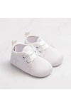 Carriage Boutique white baby christening shoes featuring a delicate embroidered cross and satin ribbon laces.