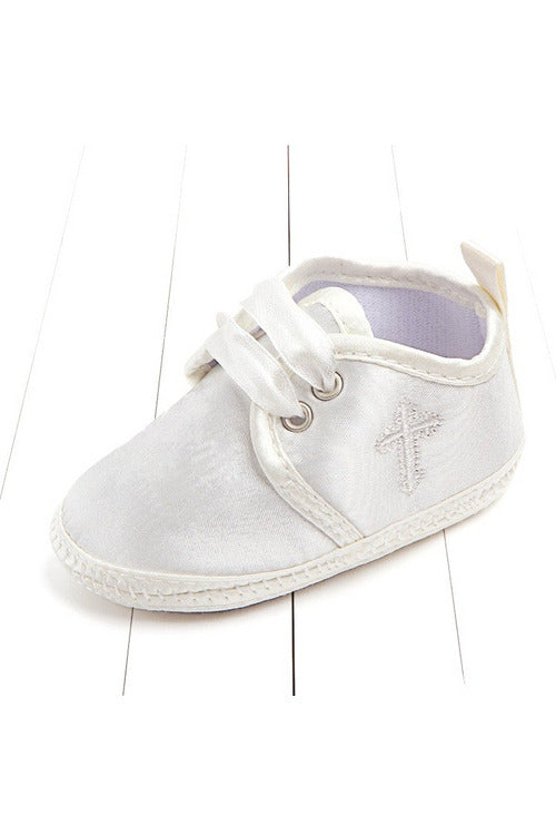 Carriage Boutique white baby christening shoes featuring a delicate embroidered cross and satin ribbon laces.