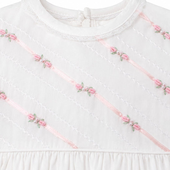 Carriage Boutique white girls gown featuring delicate pink ribbon stripes and floral embroidery with pearl accents.