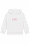 Carriage Boutique white hooded baby sweater with pink monogram embroidery on the chest and ribbed hem details.