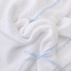 Carriage Boutique white knit baby blanket with blue satin ribbon trim and a delicate bow accent